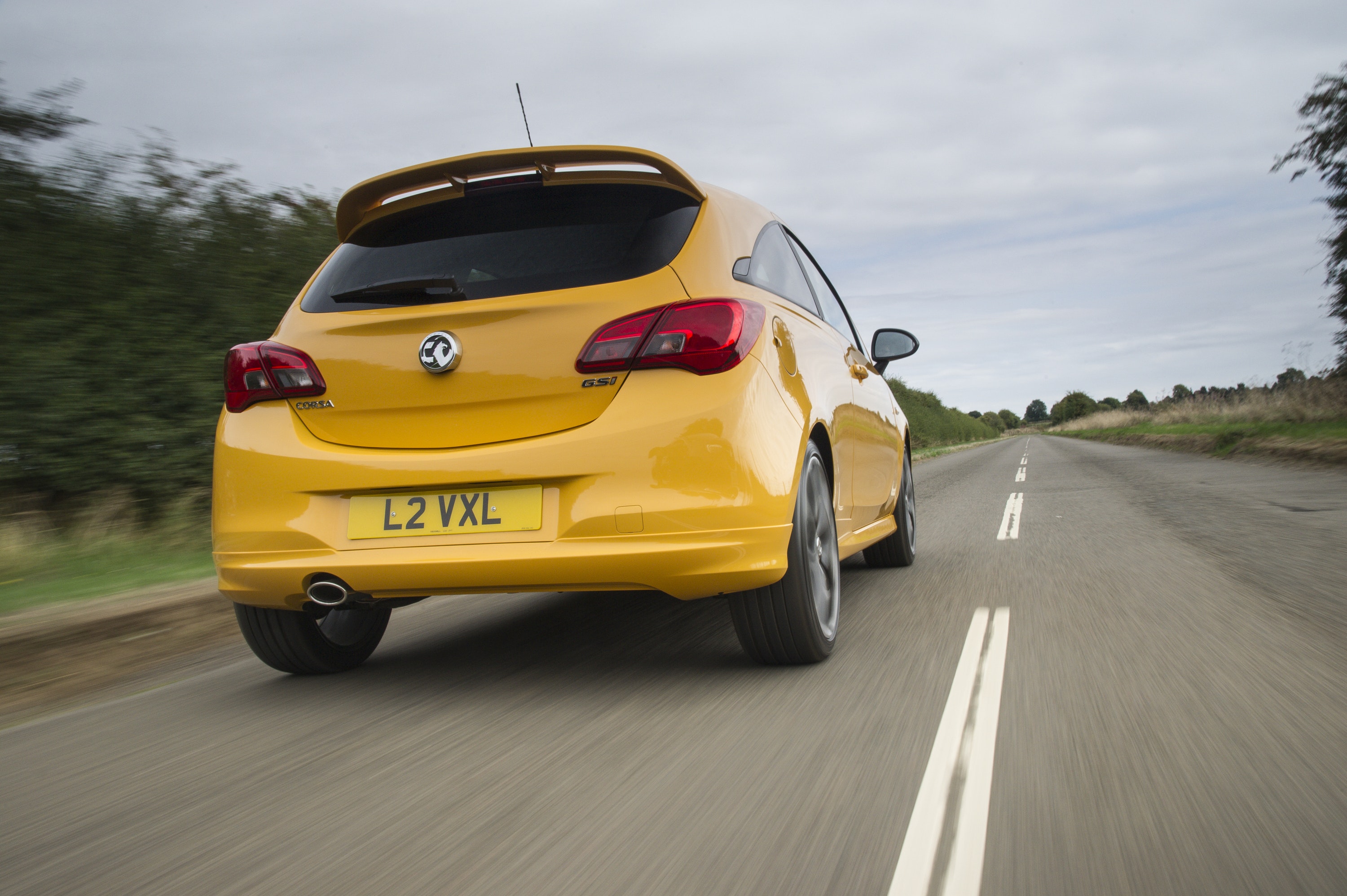 Rear view of Vauxhall Corsa driving on a road